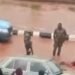 Soldiers force driver to swim in muddy water